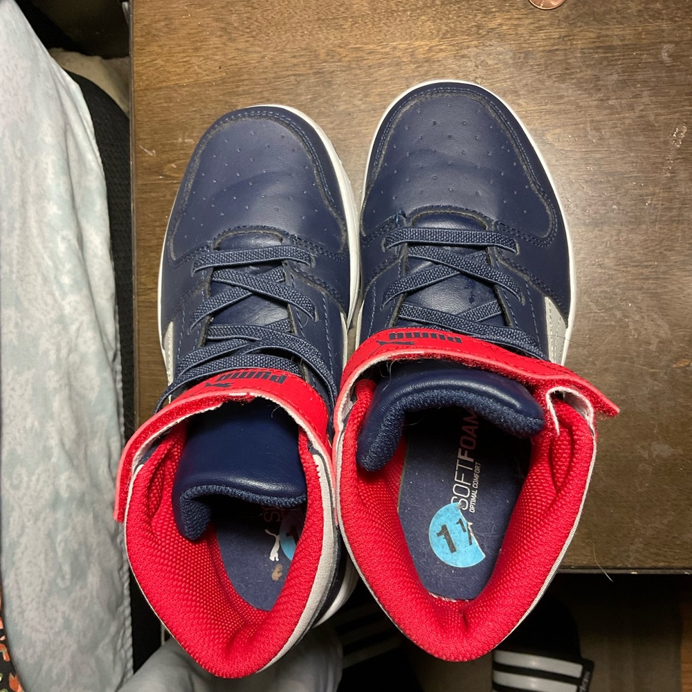 Red and blue kid puma high top.